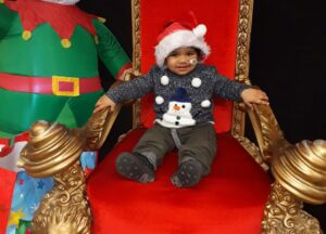 Omarni smiling on Santa's chair