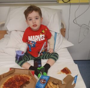 Tiernan enjoying pizza in hospital