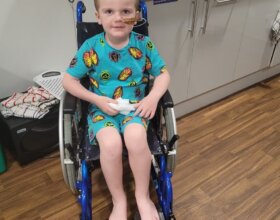 Reid in a wheelchair while currently receiving chemotherapy treatment in hospital