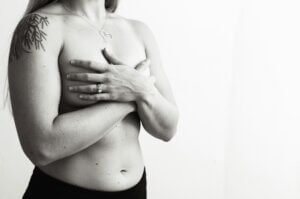 Woman with her hands covering her breasts