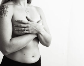 Woman with her hands covering her breasts
