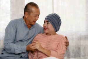 Asian senior couple - wife being supported by husband during chemotherapy