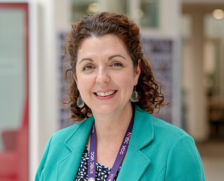 Smiling woman wearing a green jacket