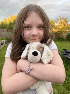 Little girl cuddling her sensory dog
