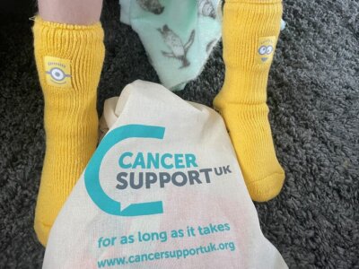Max Sheppard wearing his Minion socks Yellow Minion socks are part of Cancer Support UK's Kids' Cancer Kit