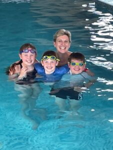 Mother swimming with her children