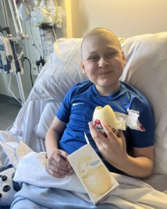 Young boy eating an Easter Egg while in hospital