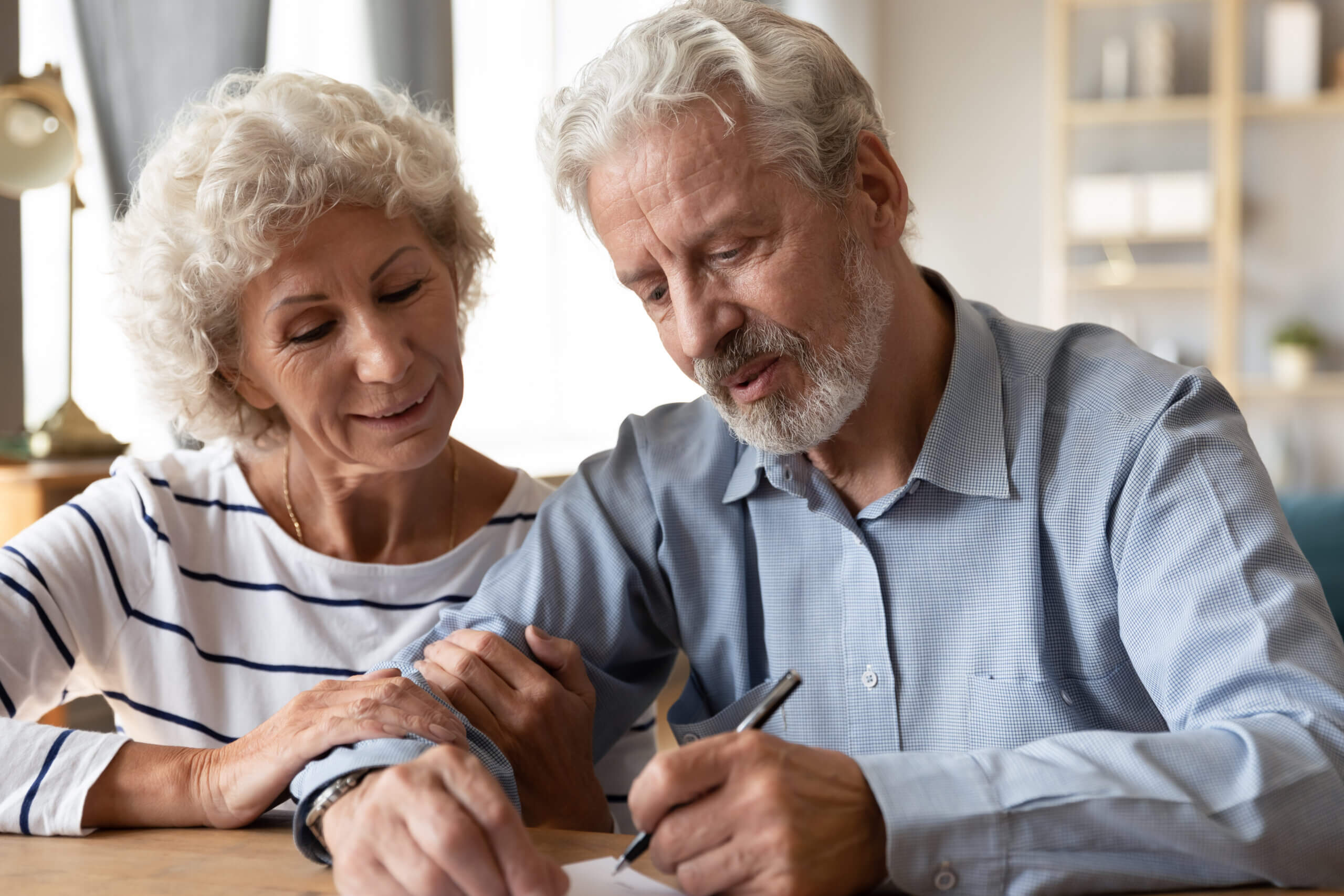 Happy,Senior,Couple,Signing,Legal,Documents,,Making,Purchasing,Deal,,Smiling